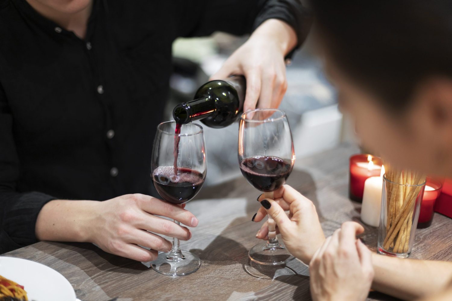 young-couple-celebrating-valentine-s-day-while-having-lunch-wine-together